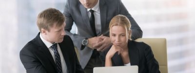 Partnership and teamwork concept Group of three business partners discussing new project at meeting in office room, using laptop. Young confident businessman in formal wear suit explaining idea and showing presentation on screen