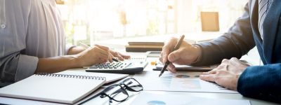 business man financial inspector and secretary making report, ca business man financial inspector and secretary making report, calculating or checking balance. Internal Revenue Service inspector checking document. Audit concept