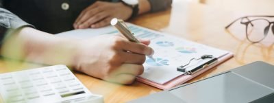 Close up a account working about financial with calculator at office to calculate expenses, Accounting concept Close up a account working about financial with calculator at office to calculate expenses, Accounting concept.