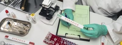 police scientist takes data from evidence box in crime lab, conceptual image